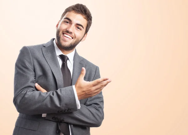 Businessman doing welcome gesture — Stock Photo, Image