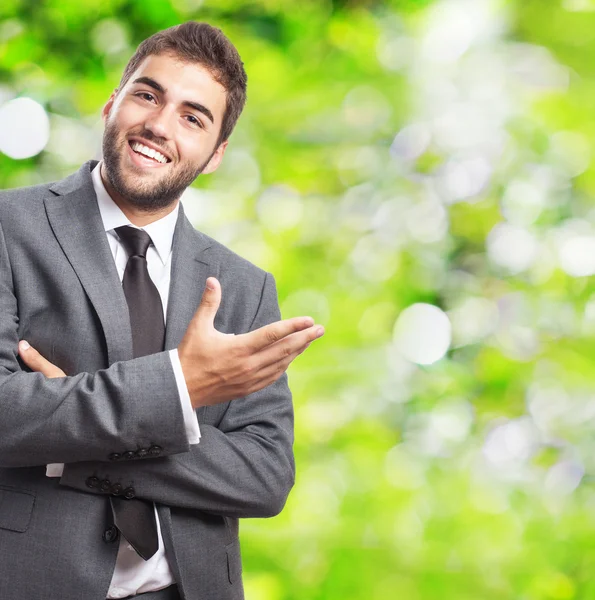 Businessman doing welcome gesture — Stock Photo, Image