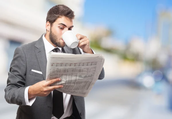 Business man drinking and reading — Stock Photo, Image