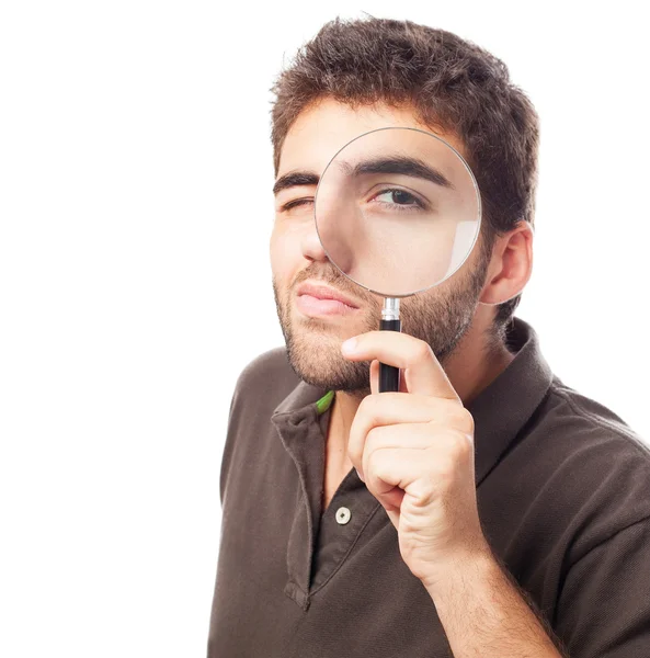 Hombre mirando a través de lupa — Foto de Stock