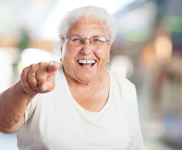 Elder woman pointing with finger — Stock Photo, Image