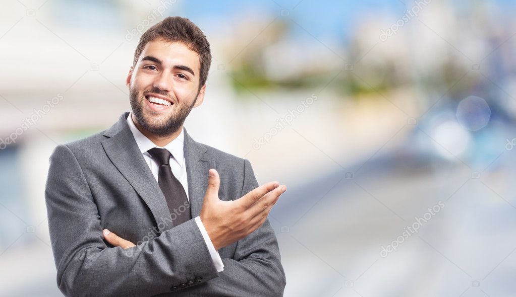 Businessman doing welcome gesture