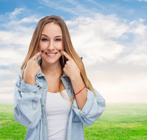 Meisje maken teken om te glimlachen — Stockfoto