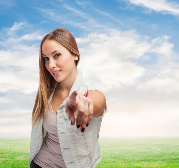 Beautiful young woman making sign to point — Stock Photo, Image