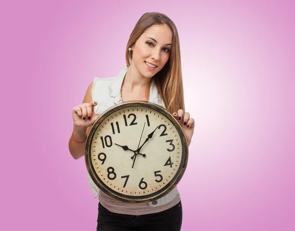 Woman holding clock — Stock Photo, Image
