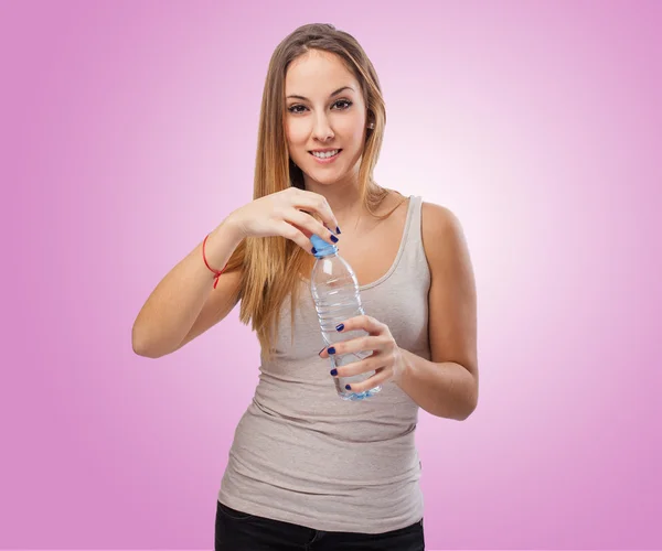 Woman opening bottle of water — Stock Photo, Image