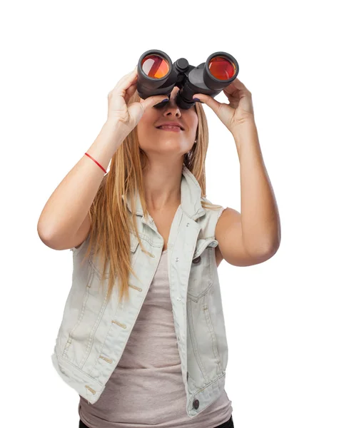 Woman looking through binoculars — Stock Photo, Image