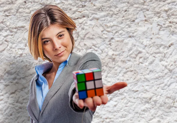 Business woman holding rubik cube — Stock Photo, Image