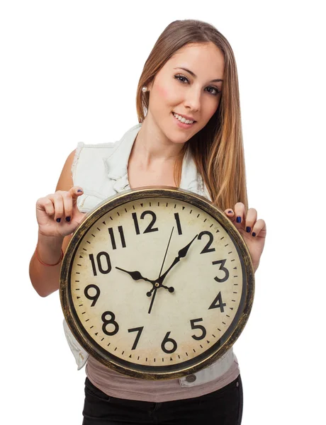 Frau hält Uhr Stockbild