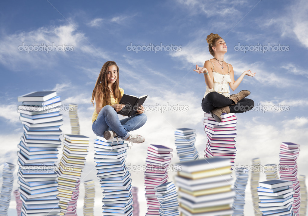 Students on book piles