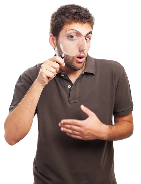 Man looking through magnifying glass — Stock Photo, Image