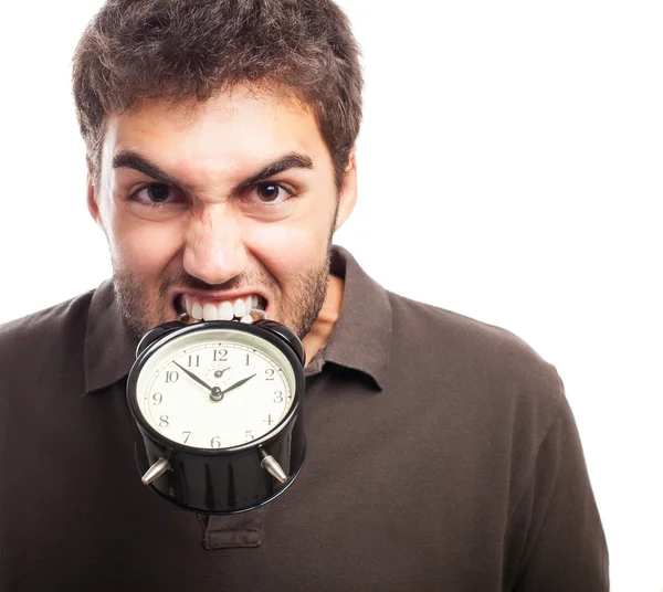 Hombre mordiendo despertador — Foto de Stock