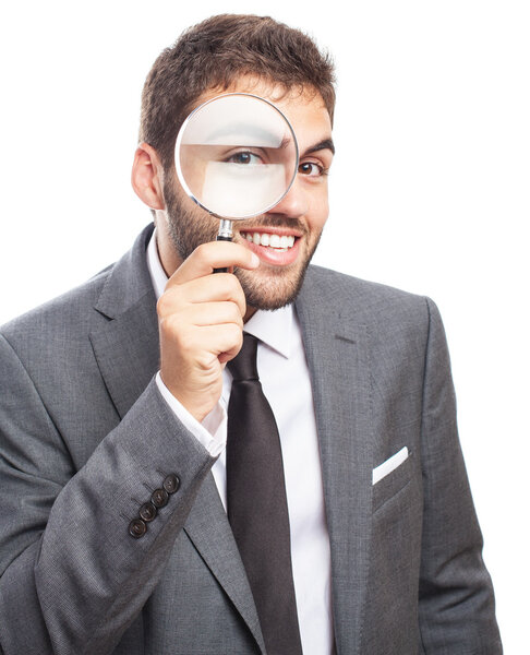 Businessman looking through magnifying glass