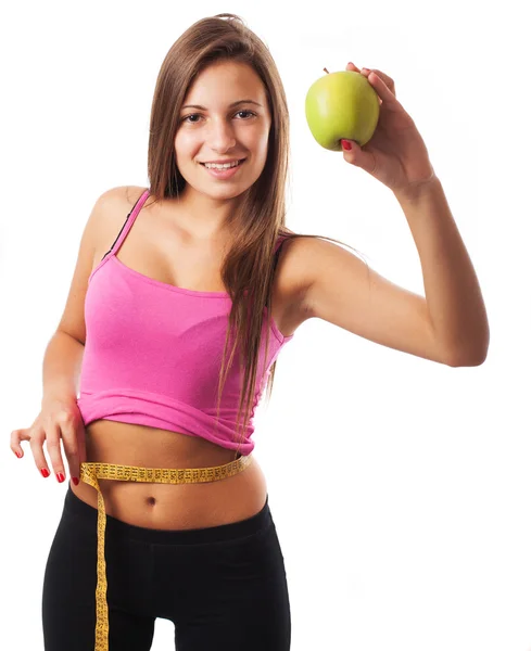 Женщина с яблоком и измерительной лентой — стоковое фото