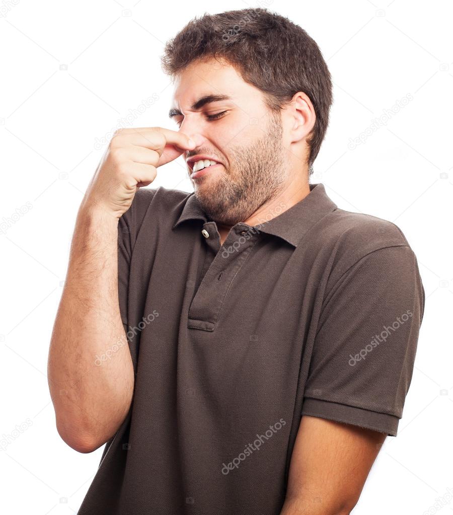 Man showing bad smelling gesture