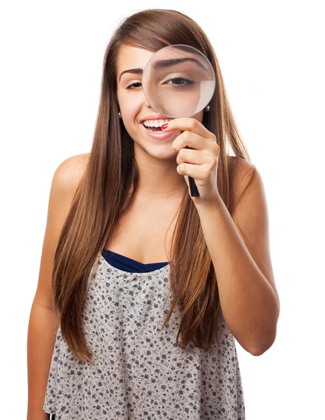 Woman looking through magnifying glass — Stock Photo, Image