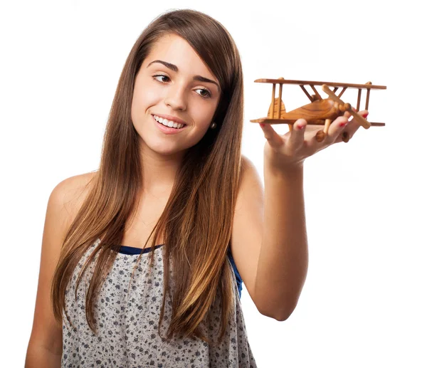 Girl holding wooden airplane — Stock Photo, Image