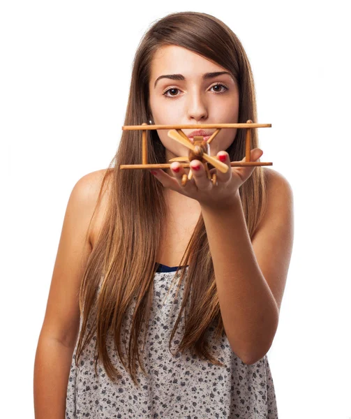 Girl holding wooden airplane — Stock Photo, Image