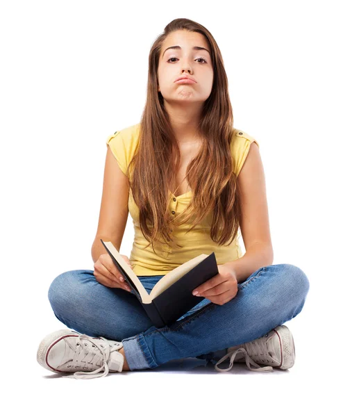 Woman bored of reading book — Stock fotografie