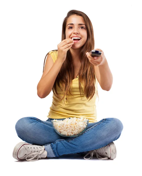 Woman eating popcorn and watching tv — Stock Photo, Image