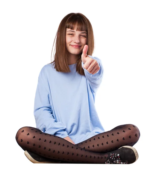 Mladá dívka ukazuje palec — Stock fotografie