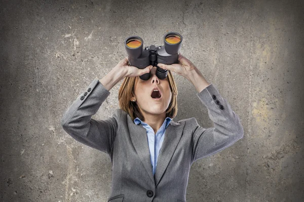 Zakenvrouw kijkt door verrekijker — Stockfoto