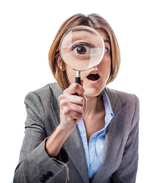 Businesswoman looking throught magnifying glass — Stock Photo, Image