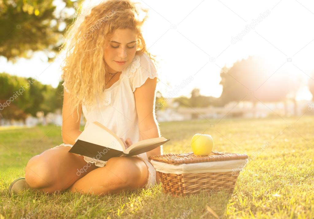 Woman reading book at park