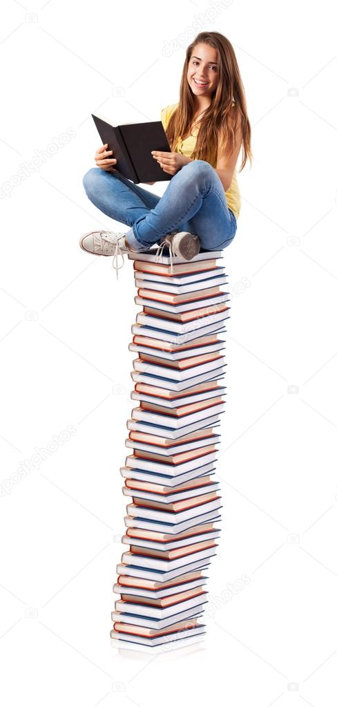 Girl sitting on books tower