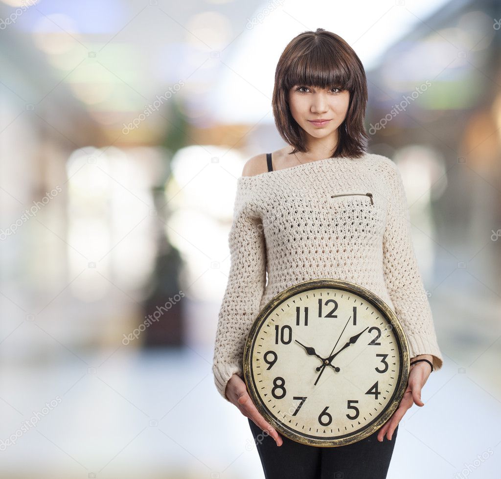 Girl holding clock