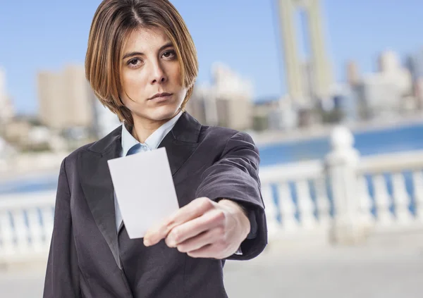 Business woman holding card — Stock Photo, Image