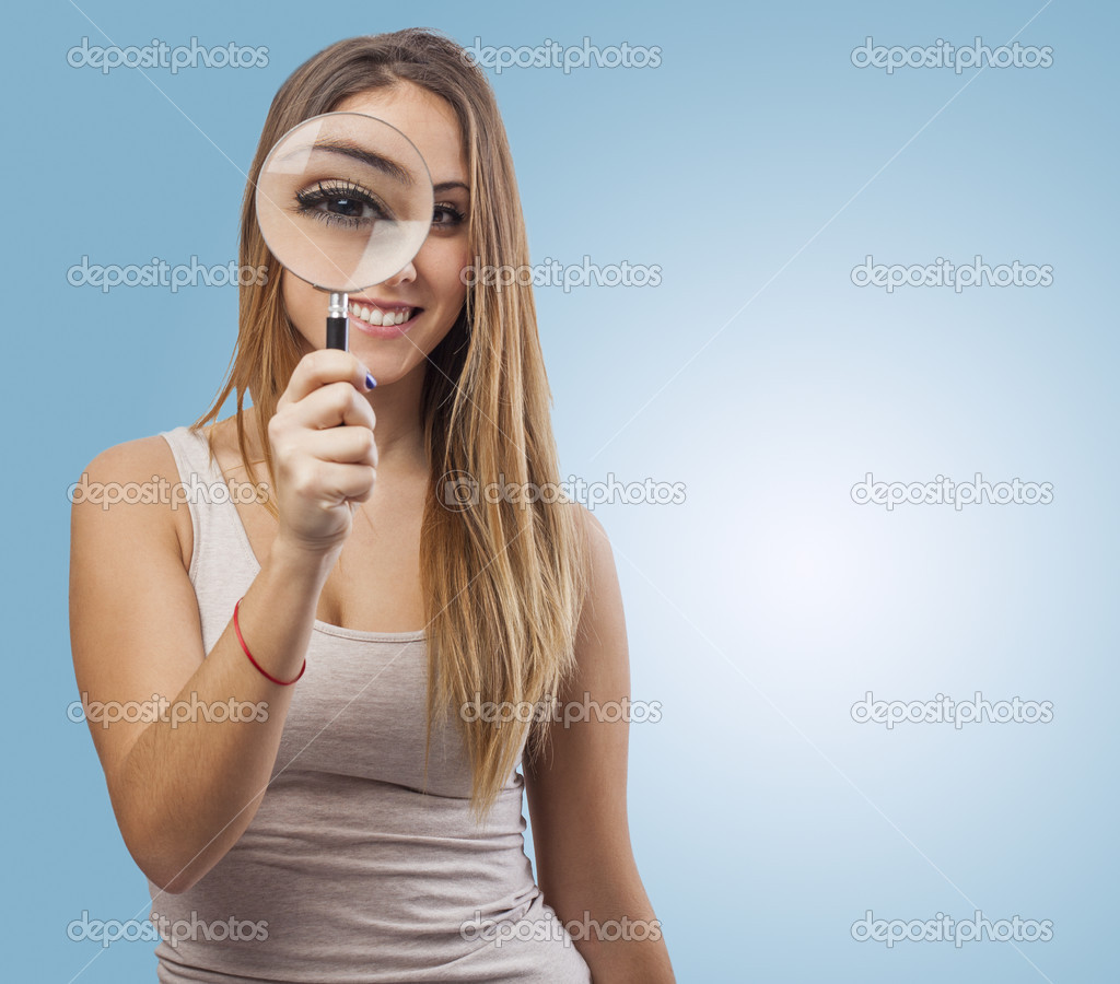 Woman looking through magnifying glass