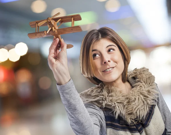 Mujer jugando con avión de madera —  Fotos de Stock