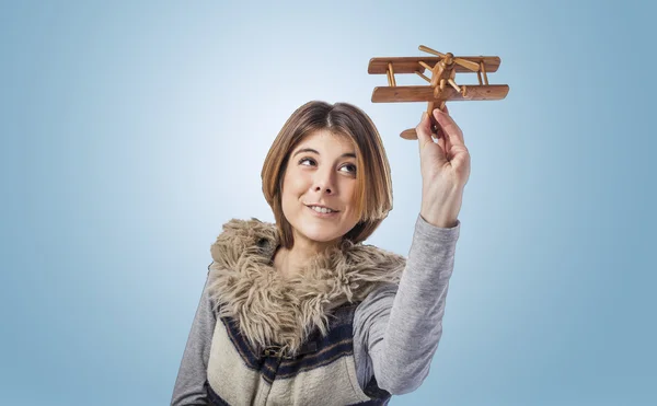Woman playing with wooden plane — Stock Photo, Image