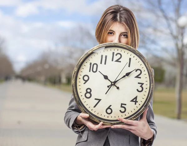 Business woman holding clock — Stock Photo, Image