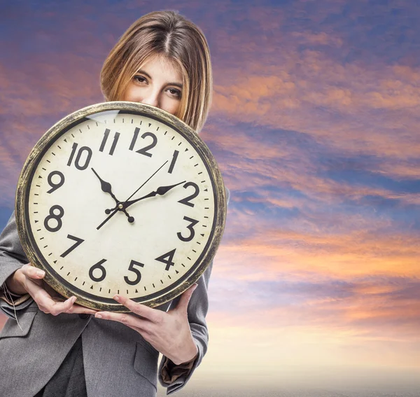 Business woman holding clock — Stock Photo, Image