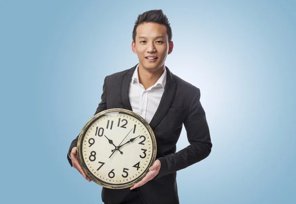 Business man holding clock — Stock Photo, Image