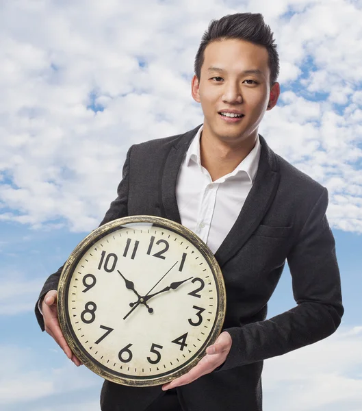 Business man holding clock — Stock Photo, Image