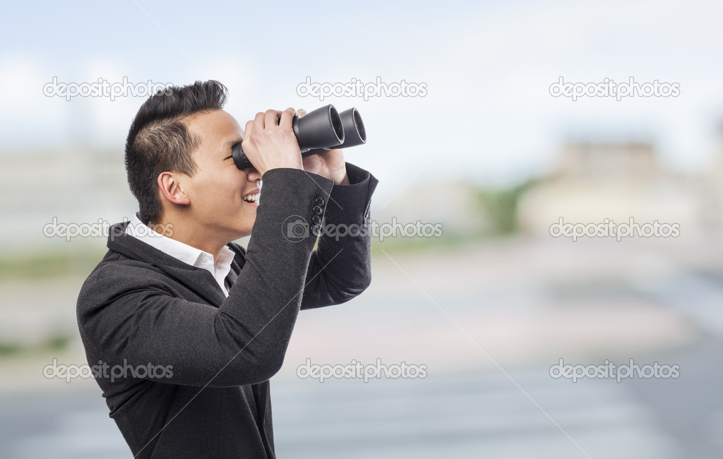 Man looking trough binoculars