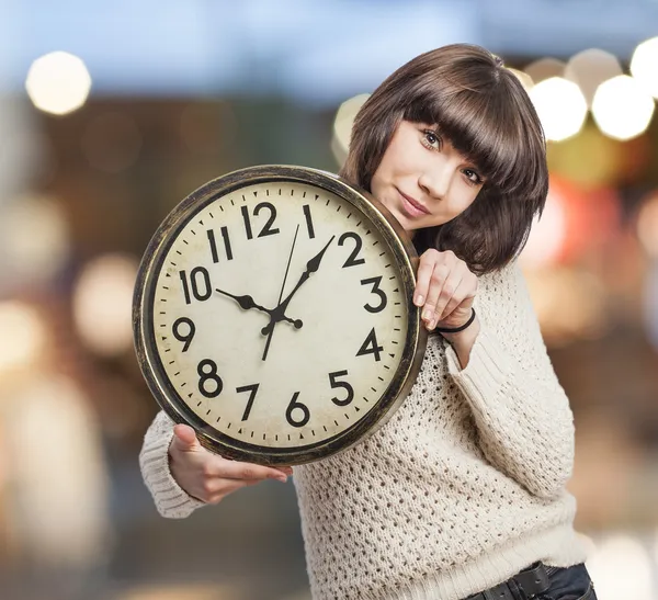 Woman holding clock — Stock Photo, Image