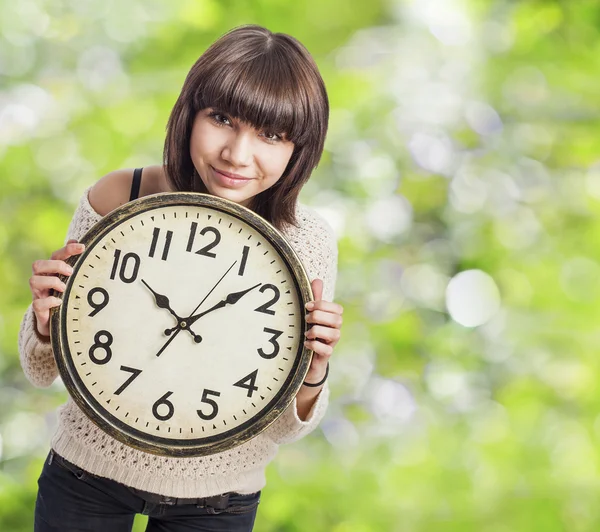 Woman holding clock — Stock Photo, Image