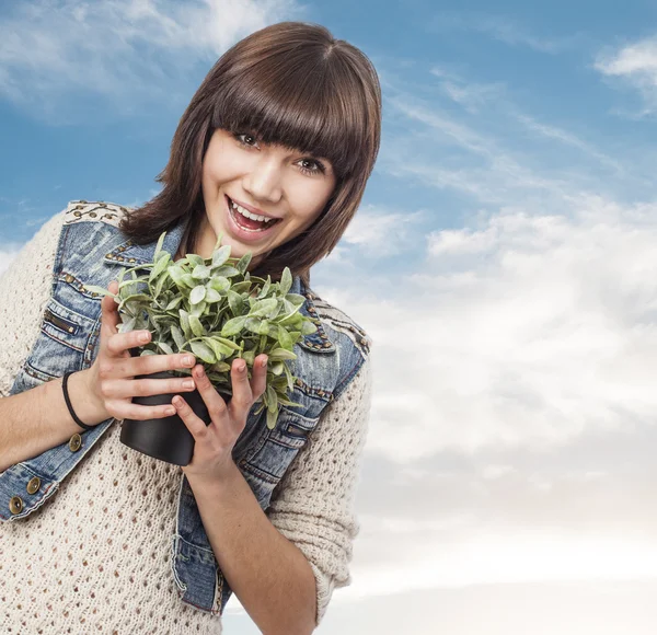 Woman holding plant — Stock Photo, Image