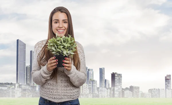 Woman holding plant — Stock Photo, Image