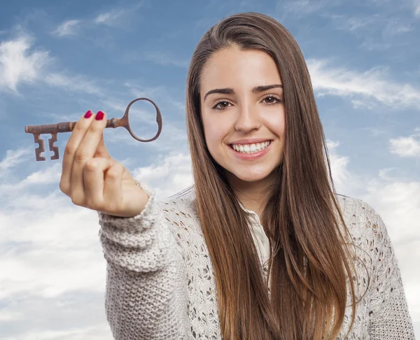 Woman holding key — Stock Photo, Image