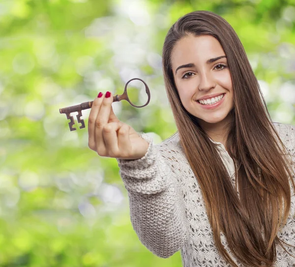 Woman holding key — Stock Photo, Image