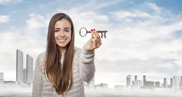 Woman holding key — Stock Photo, Image