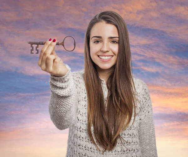 Woman holding key — Stock Photo, Image