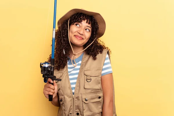 Young Mixed Race Fisherwoman Holding Rod Isolated Yellow Background Dreaming — Stock Photo, Image