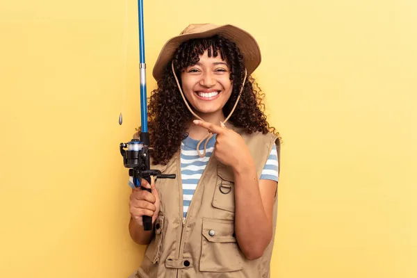 Young Mixed Race Fisherwoman Holding Rod Isolated Yellow Background Smiling — Stock Photo, Image