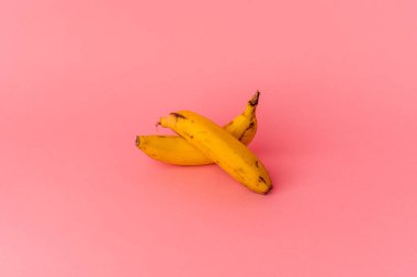 Pembe arka planda izole edilmiş iki muz